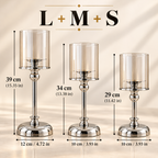 Glass pillar candle holders in three different sizes arranged together as a decorative set