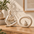 Abstract thinker sculpture displayed beside a sculptural vase on a warm Scandinavian console