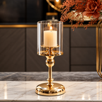 Single silver glass pillar candle holders with a clear glass cylinder and polished silver base