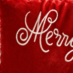 Close-up of red Christmas pillow covers with elegant white embroidered lettering.