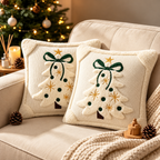 Embroidered Christmas pillow covers with white Christmas tree patterns and red bows styled on a festive sofa.