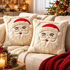 Pair of cream Christmas cushion covers featuring raised 3D Santa faces for seasonal sofa decoration.