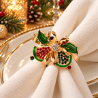 Christmas napkin rings featuring a gold-tone festive decoration with sparkling details on ivory linen.