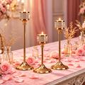 3-piece gold candle holder set arranged on a romantic table with pink roses and candles