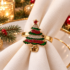 Christmas napkin rings with a decorative red and gold holiday ornament on a white napkin.