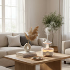 A small tabletop humidifier and diffuser with a UFO-shaped top, glowing warm light, and simulated raindrop effect, shown on a wooden surface with a remote control. Text on the image reads 'Simulate raindrops' and describes humidification and aromatherapy.