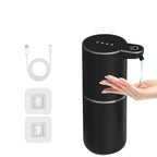 Black soap dispenser with USB cable and wall outlet adapter on a white background
